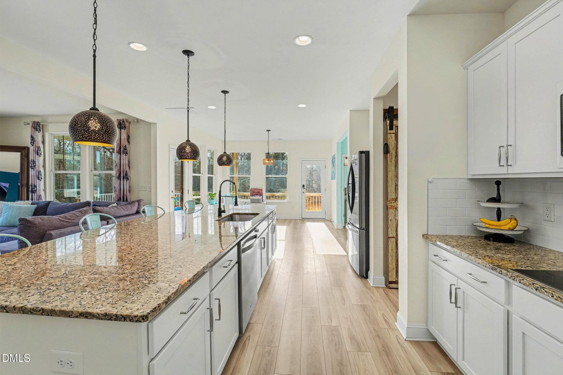 185 Twilight Trail Willow Spring, NC 27592 - Photo 18 of 42 a kitchen with stainless steel appliances granite countertop a lot of counter space and wooden floor