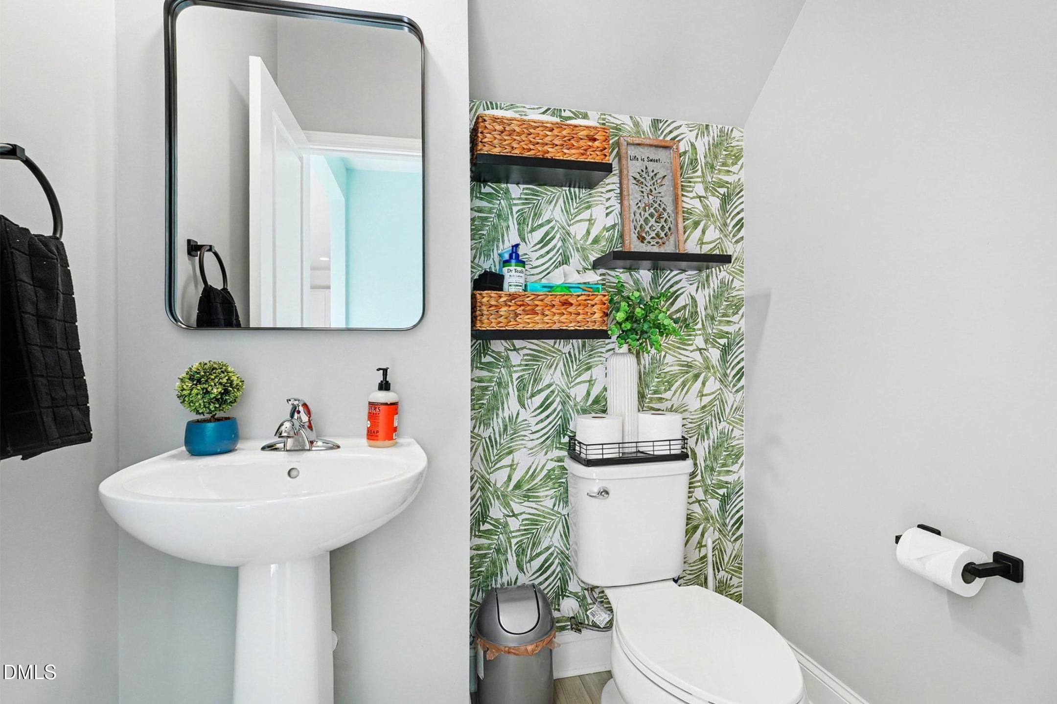 185 Twilight Trail Willow Spring, NC 27592 - Photo 19 of 42 a bathroom with a toilet sink and mirror