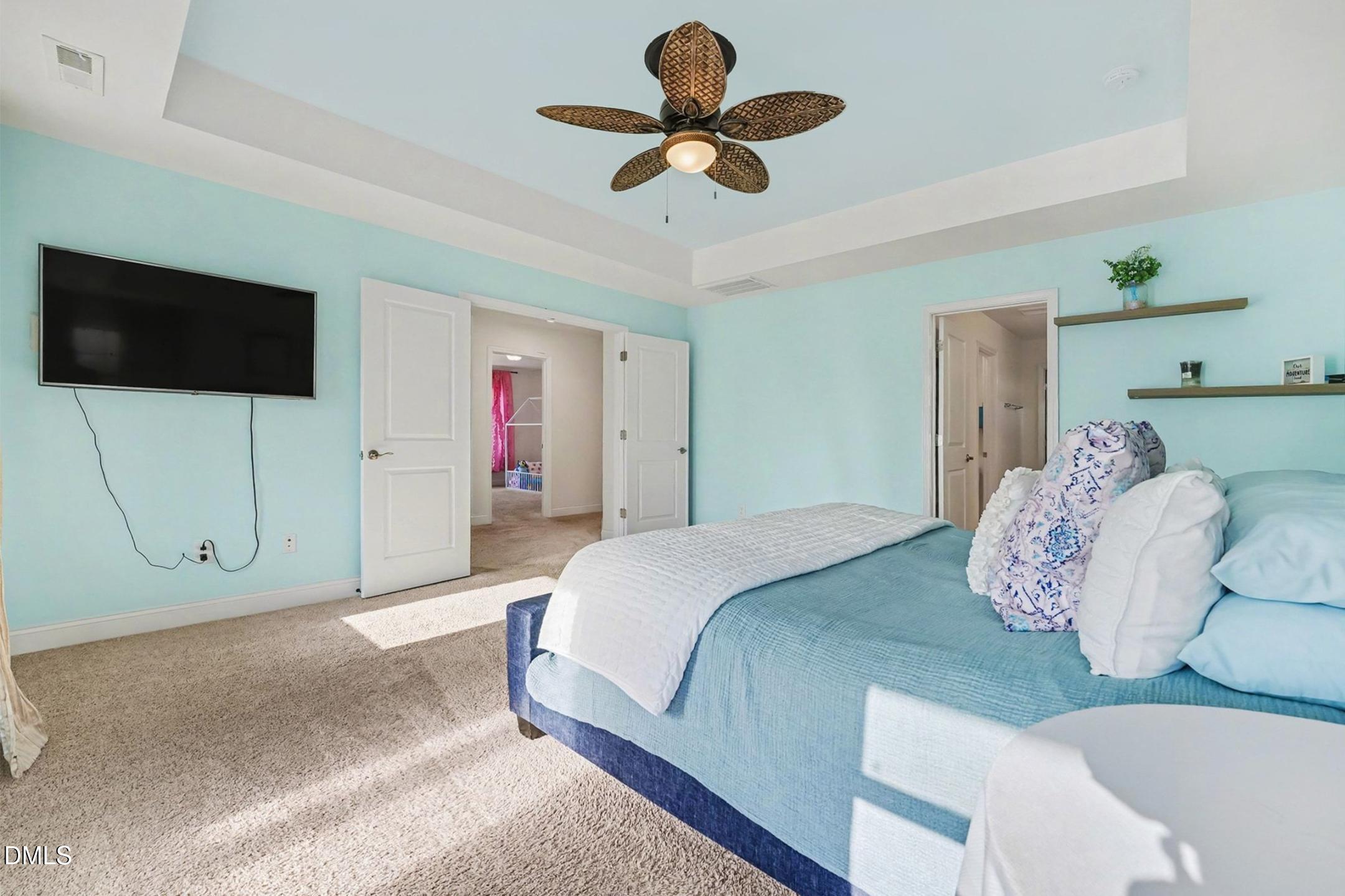 185 Twilight Trail Willow Spring, NC 27592 - Photo 21 of 42 a bedroom with a bed and a flat screen tv