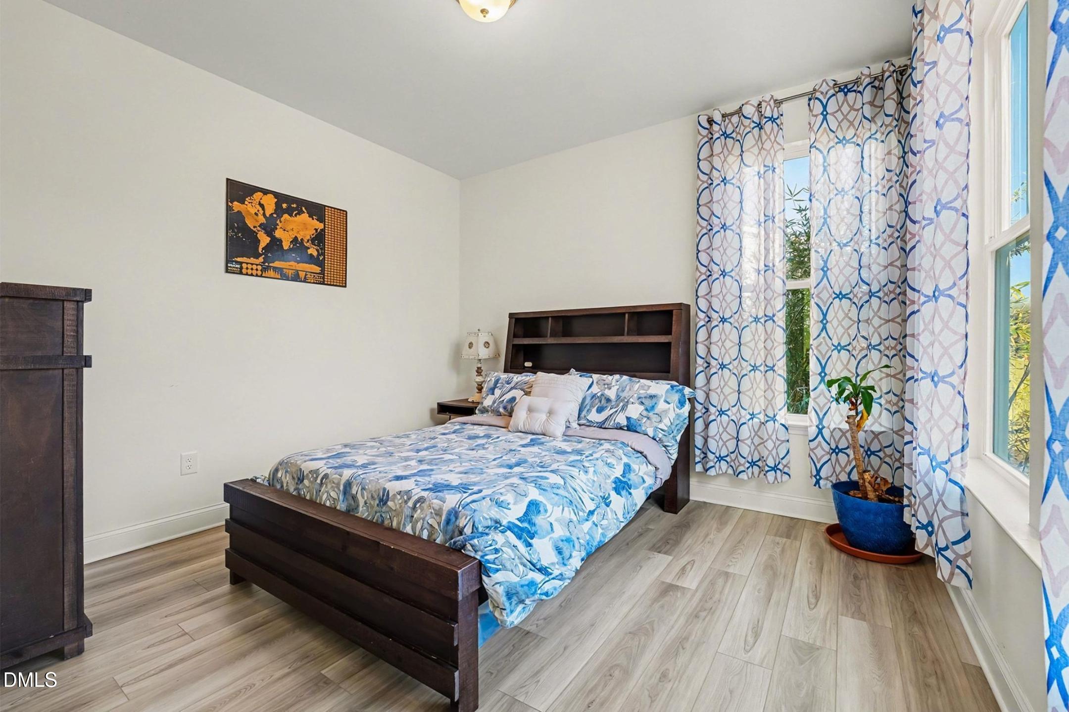 185 Twilight Trail Willow Spring, NC 27592 - Photo 22 of 42 a bedroom with a bed and a potted plant