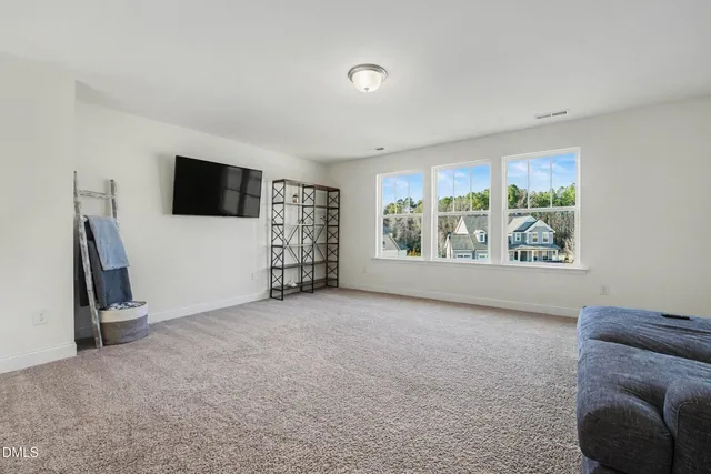 a living room with furniture and a ceiling fan