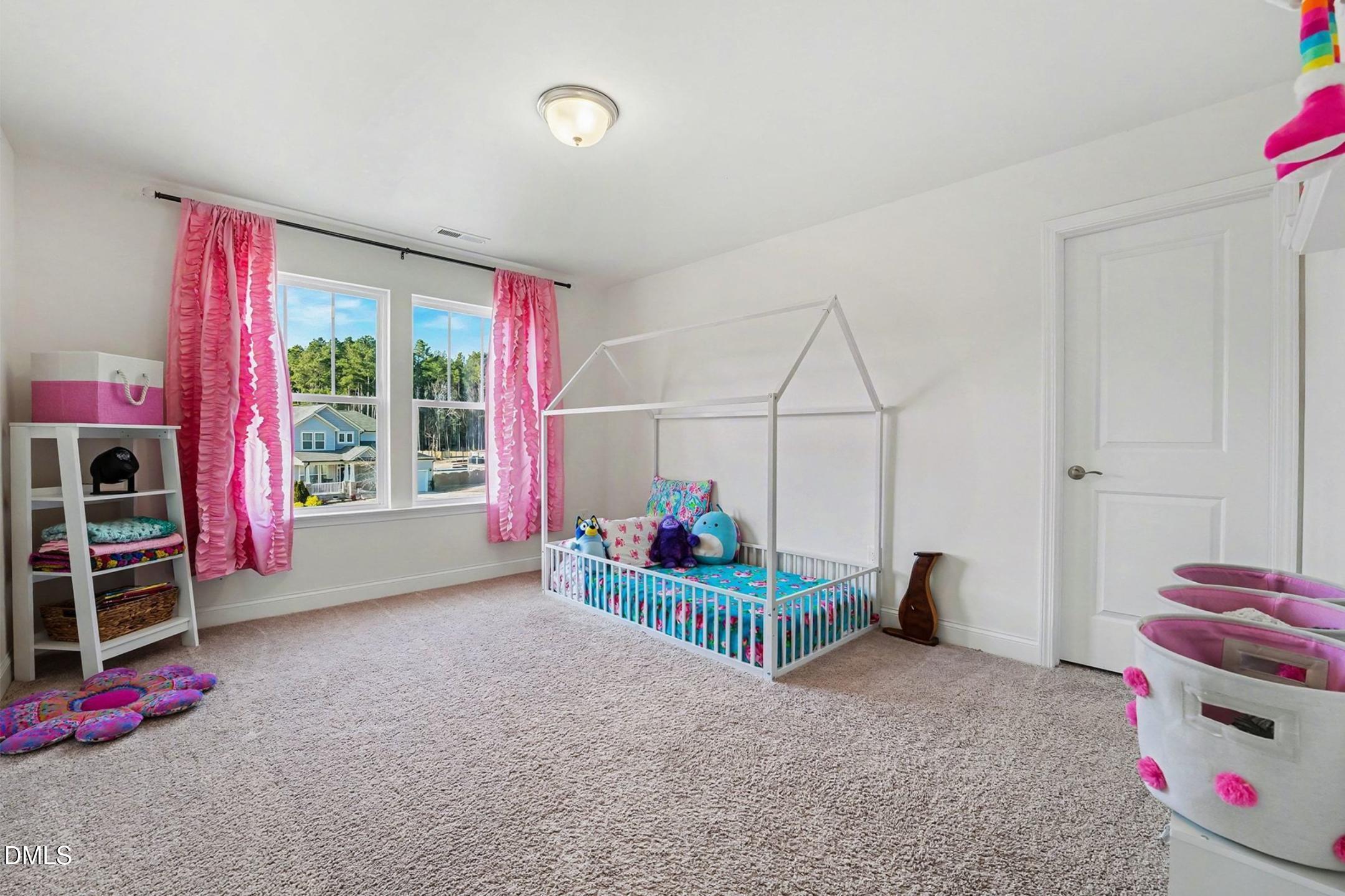 185 Twilight Trail Willow Spring, NC 27592 - Photo 26 of 42 a bedroom with furniture and a large window