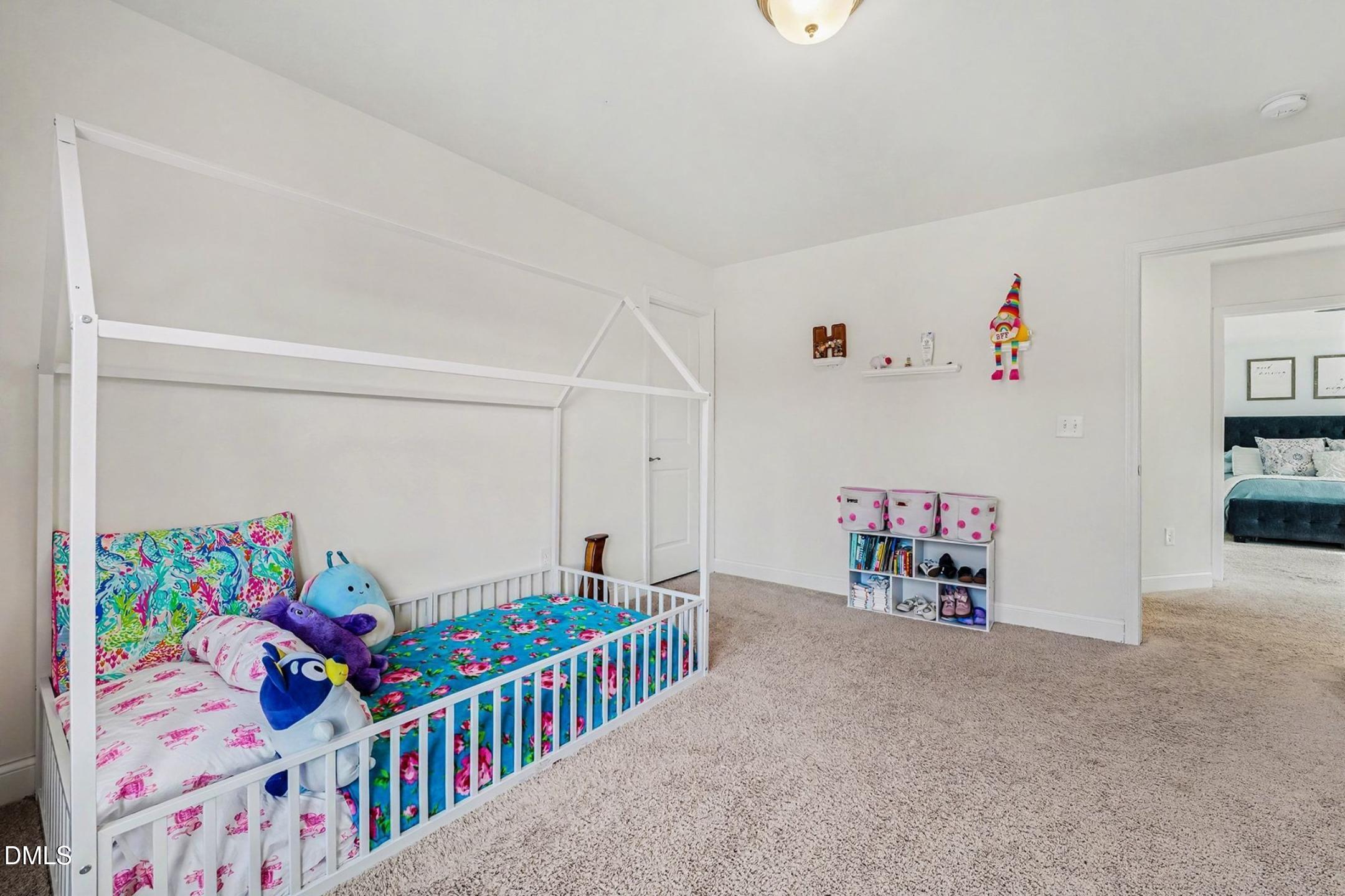 185 Twilight Trail Willow Spring, NC 27592 - Photo 27 of 42 a bedroom with furniture a baby crib and a couch