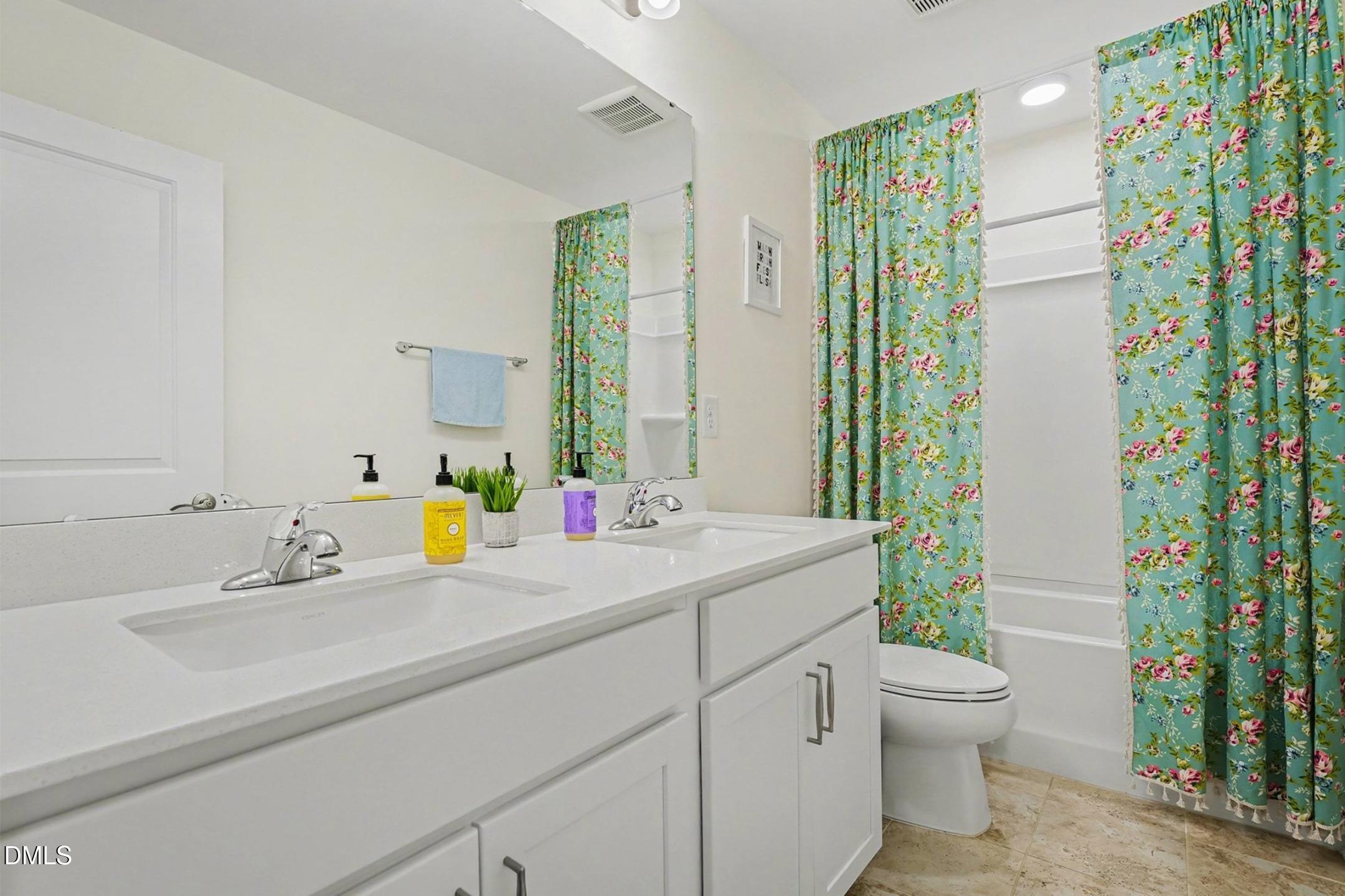 185 Twilight Trail Willow Spring, NC 27592 - Photo 28 of 42 a bathroom with a sink a toilet and a mirror