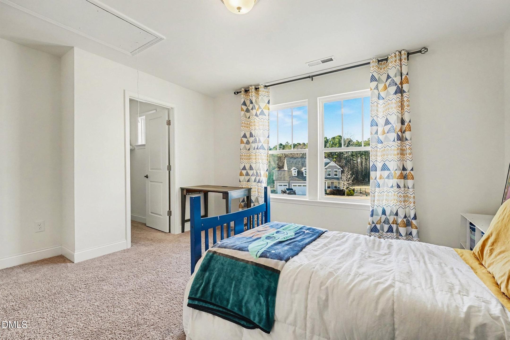 185 Twilight Trail Willow Spring, NC 27592 - Photo 30 of 42 a bedroom with a bed and a window