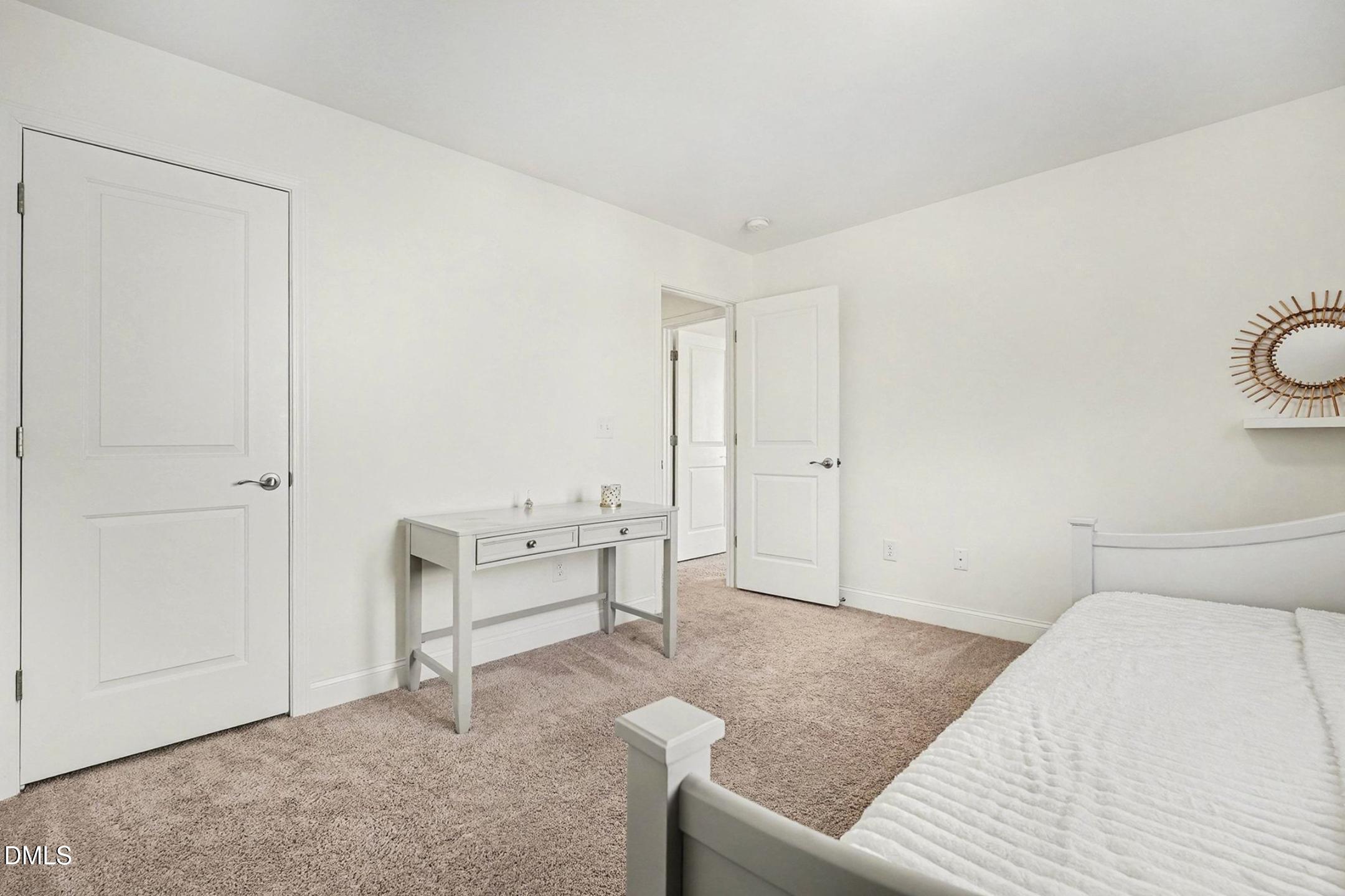 185 Twilight Trail Willow Spring, NC 27592 - Photo 31 of 42 a bedroom with a bed and white cabinets