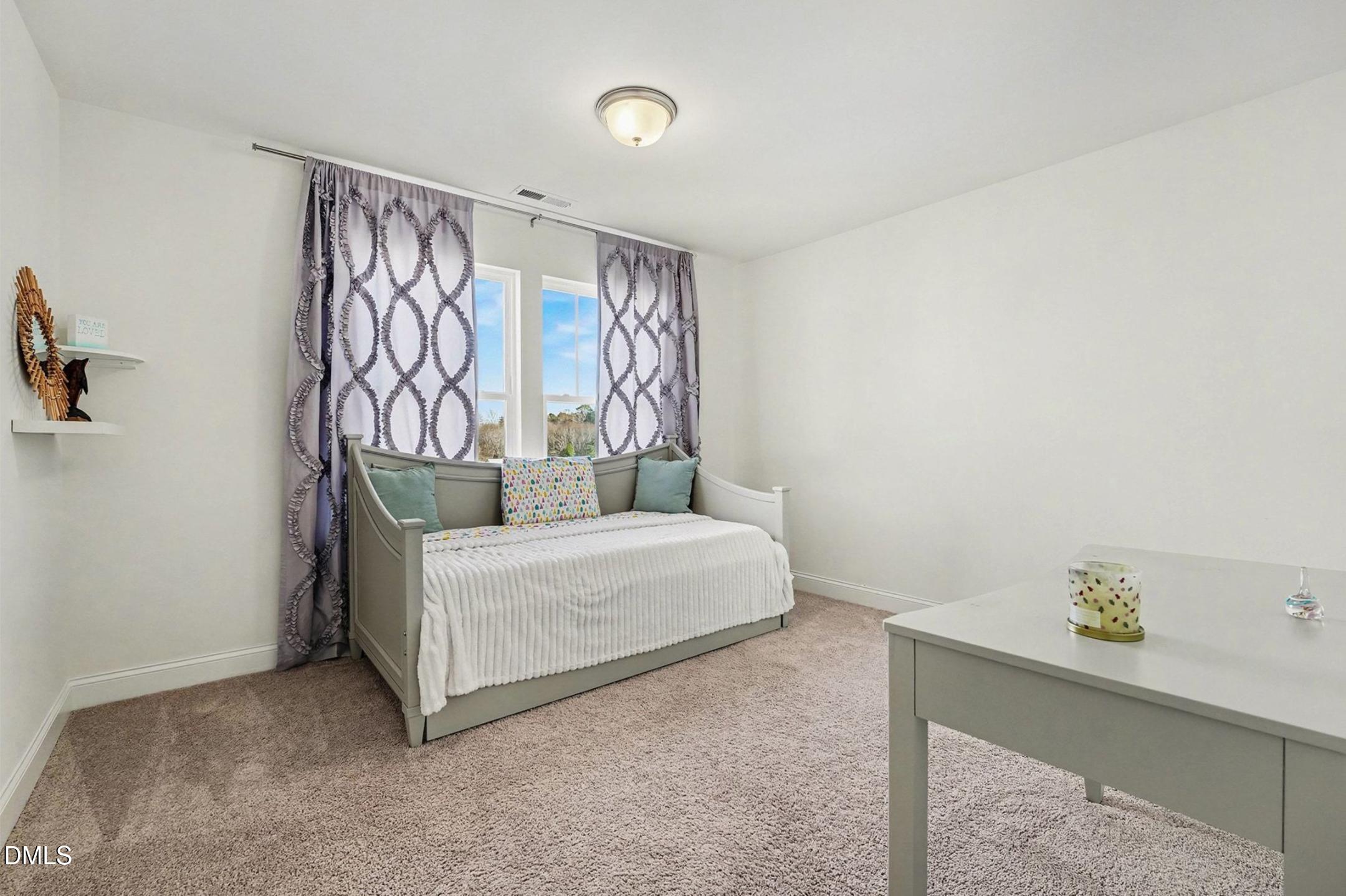 185 Twilight Trail Willow Spring, NC 27592 - Photo 32 of 42 a bedroom with a bed and a window