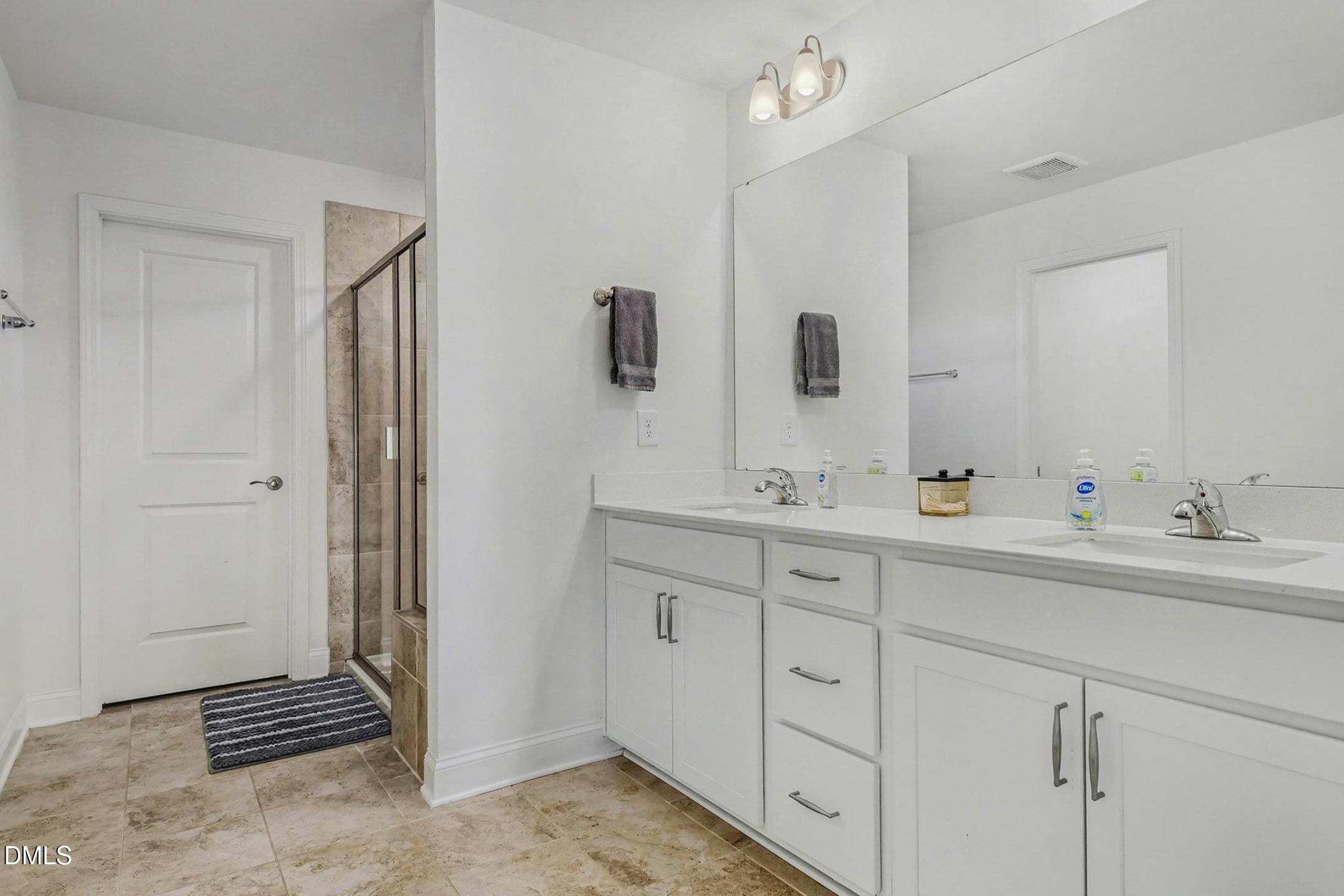 185 Twilight Trail Willow Spring, NC 27592 - Photo 33 of 42 a bathroom with double sink and a mirror