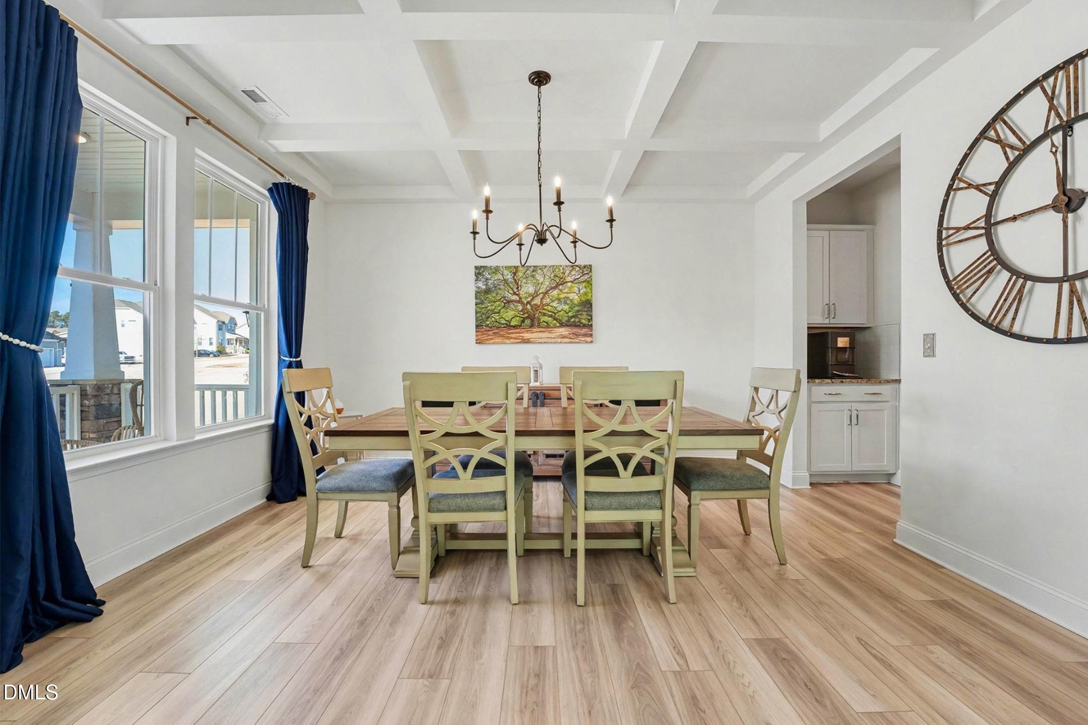 185 Twilight Trail Willow Spring, NC 27592 - Photo 9 of 42 a dining room with furniture a chandelier and wooden floor