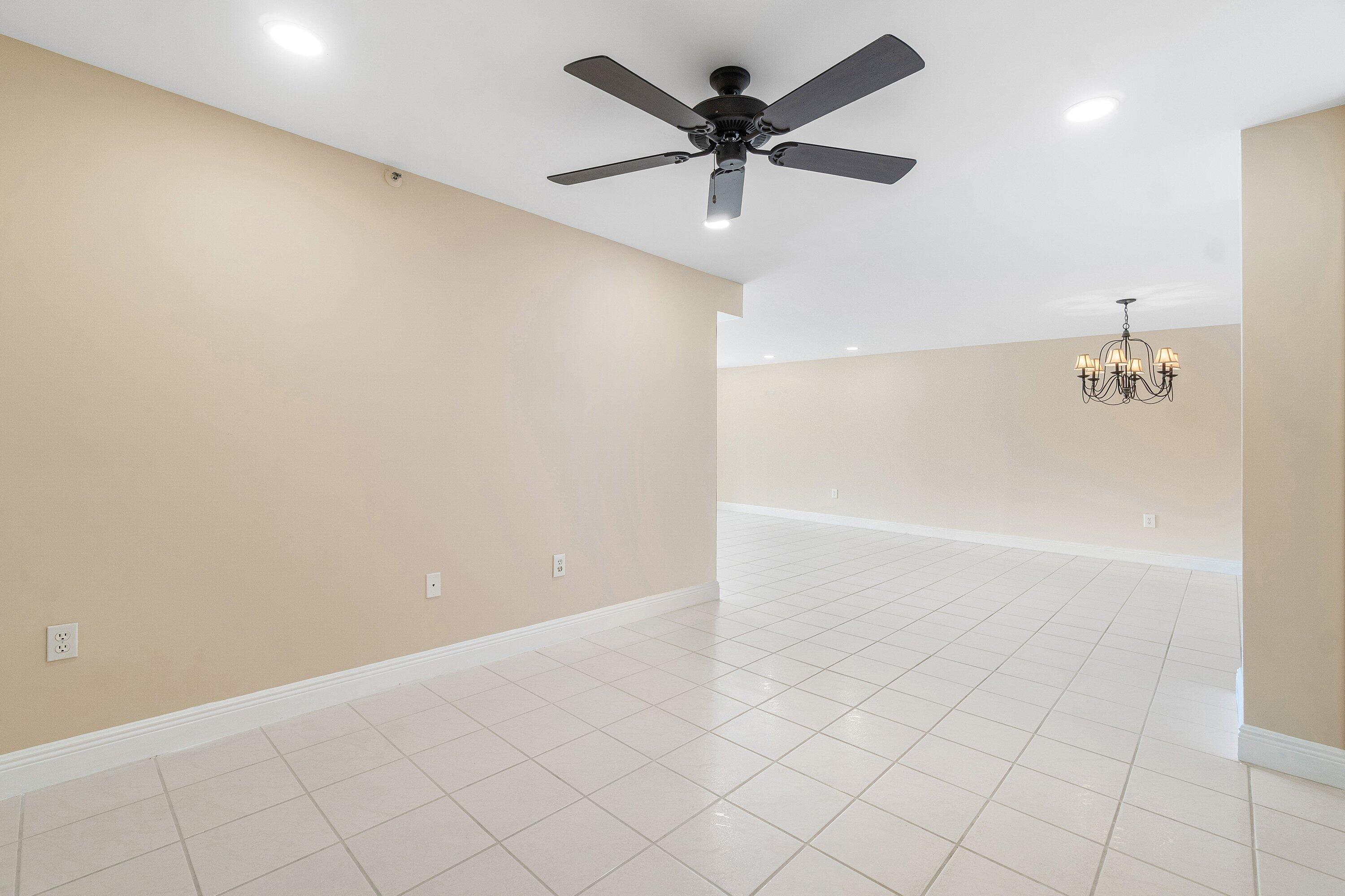 14096 Huntington Pointe Drive, Unit 106 Delray Beach, FL 33484 - Photo 16 of 47 an empty room with a ceiling fan and shower