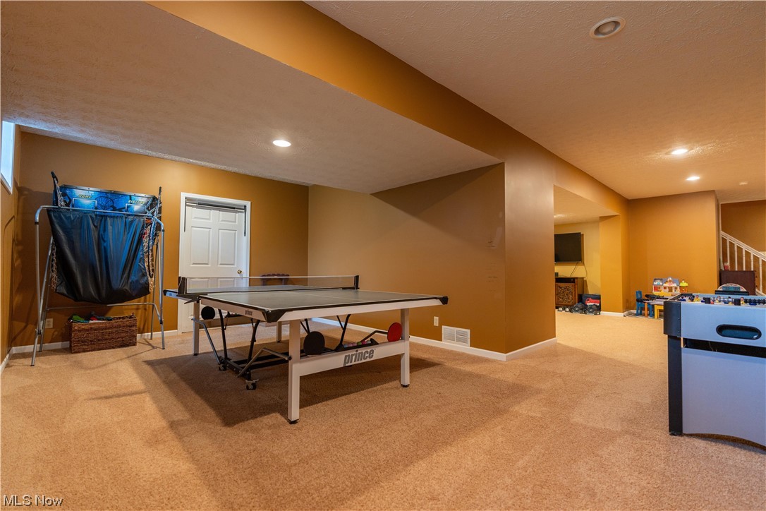 939 Pontius Road Mogadore, OH 44260 - Photo 28 of 35 Rec room featuring light colored carpet and a textured ceiling