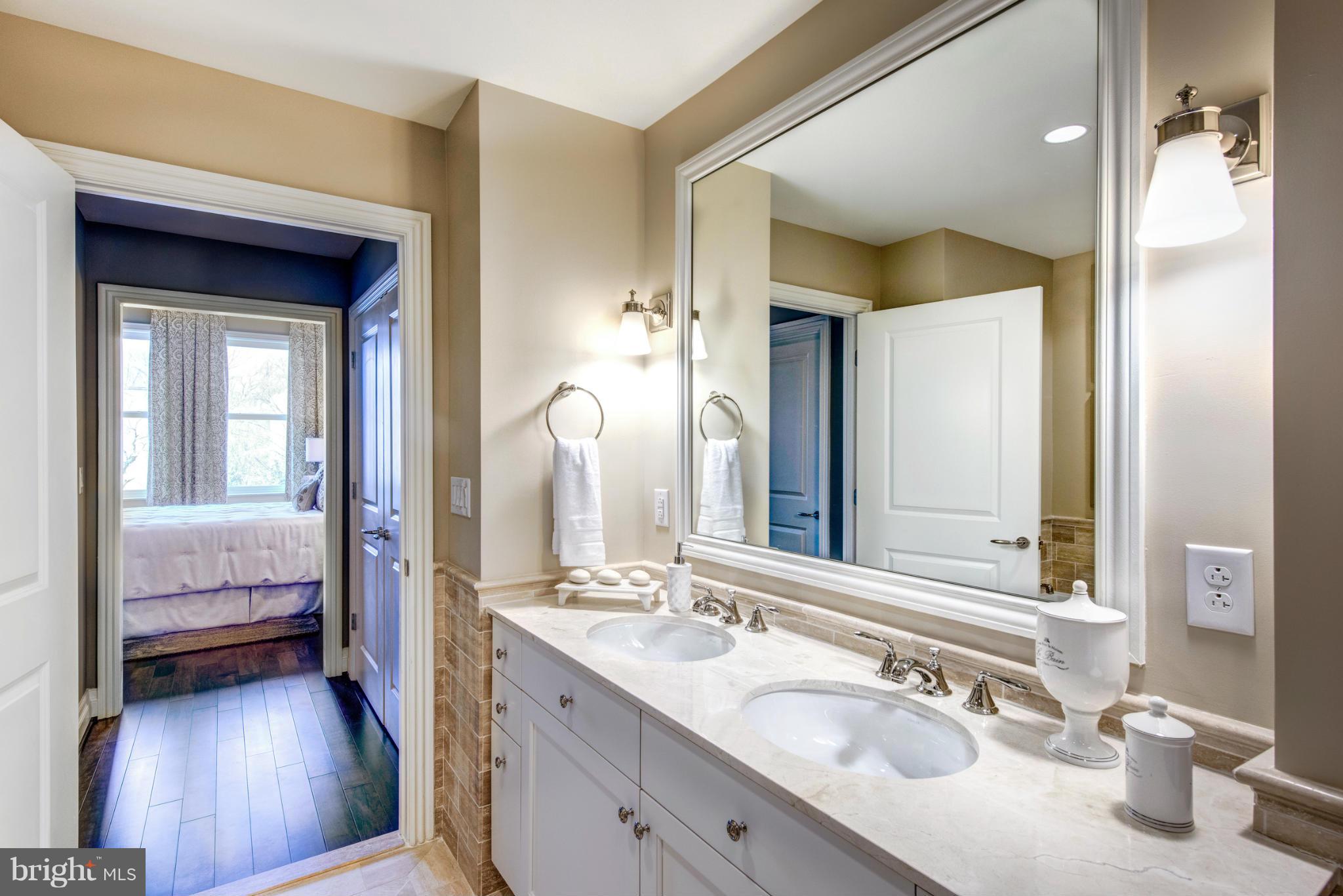 2700 Woodley Road Northwest, Unit VARIES 221 Washington, DC 20008 - Photo 11 of 29 a en suite bathroom with a double vanity sink and a mirror