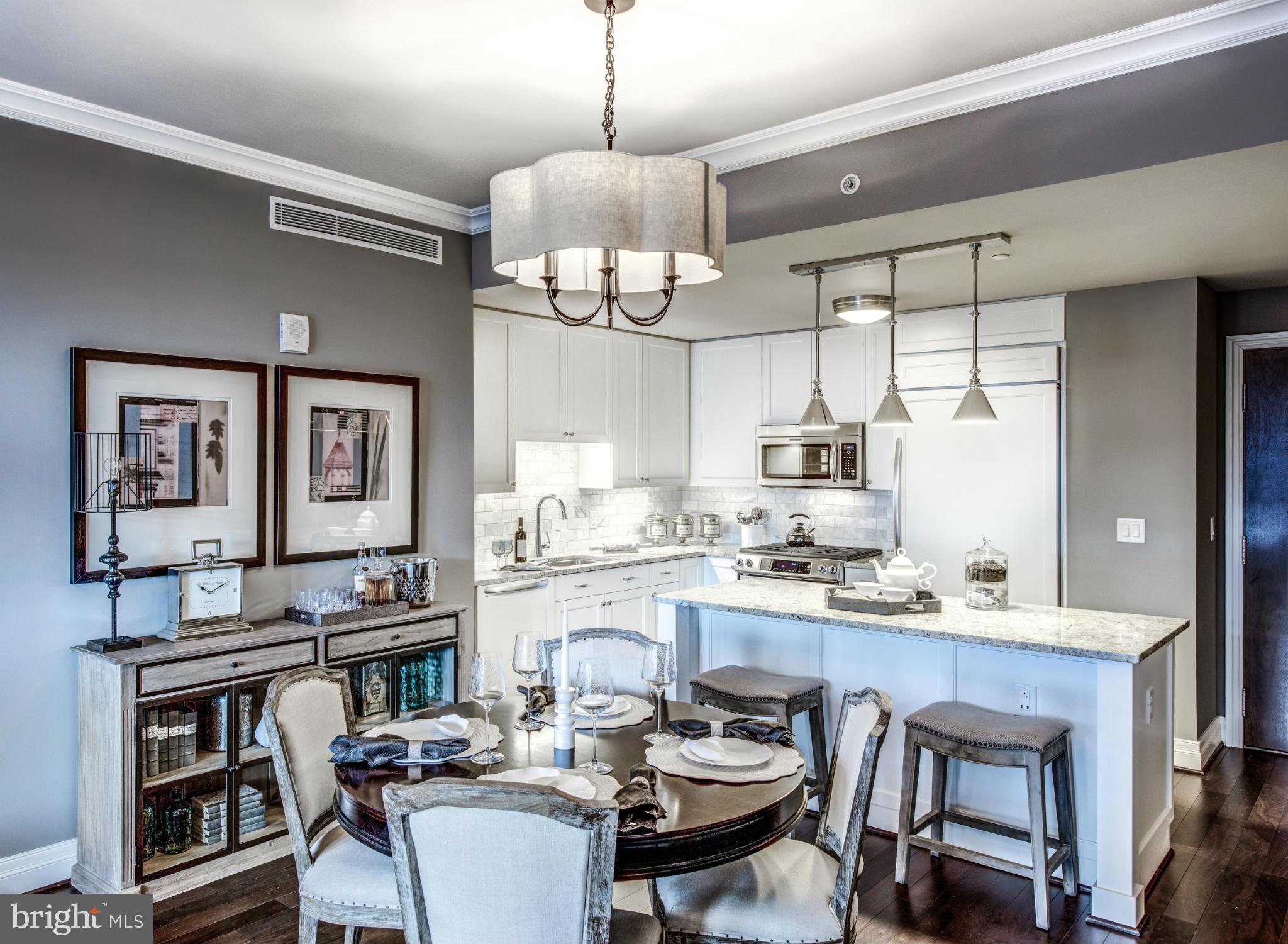 2700 Woodley Road Northwest, Unit VARIES 221 Washington, DC 20008 - Photo 3 of 29 a kitchen with a dining table and chairs