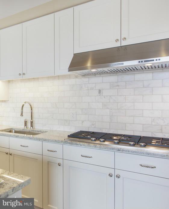 2700 Woodley Road Northwest, Unit VARIES 221 Washington, DC 20008 - Photo 7 of 29 a kitchen with granite countertop white cabinets and white appliances