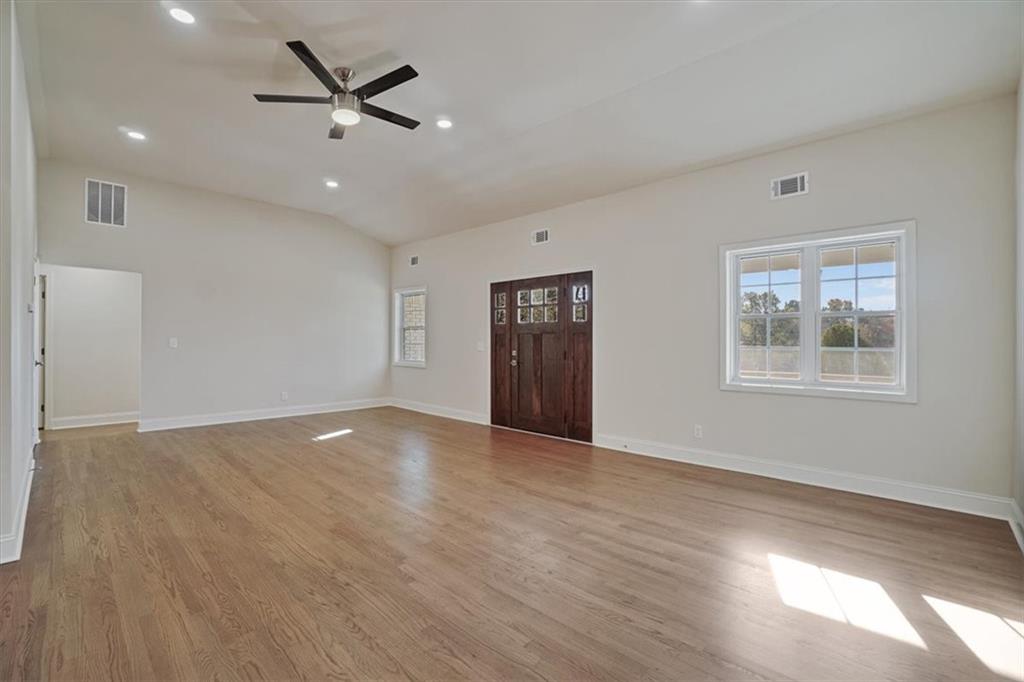 3062 Katherine Valley Road Decatur, GA 30032 - Photo 12 of 61 a view of an empty room with a window and wooden floor