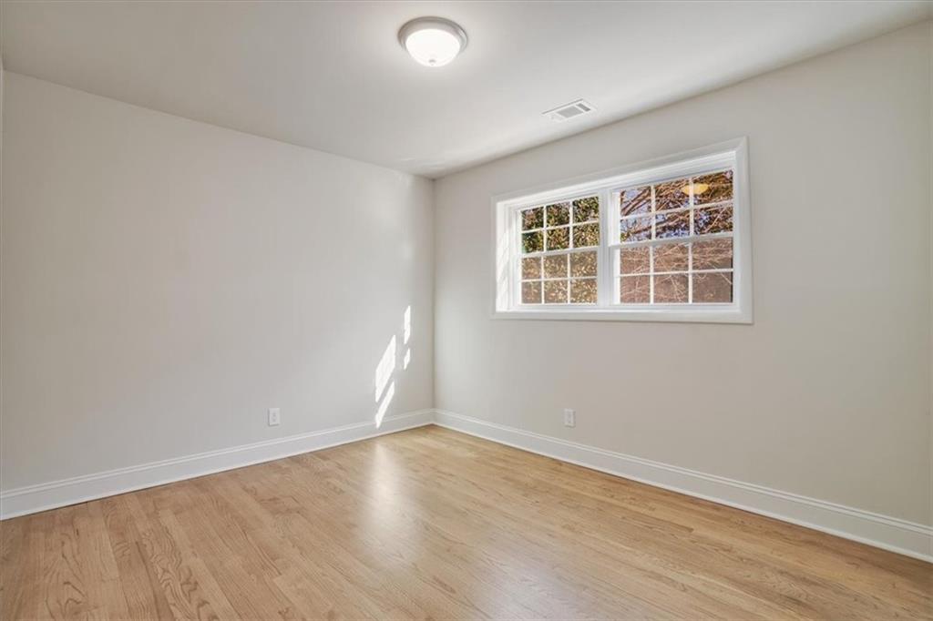 3062 Katherine Valley Road Decatur, GA 30032 - Photo 31 of 61 an empty room with wooden floor and windows