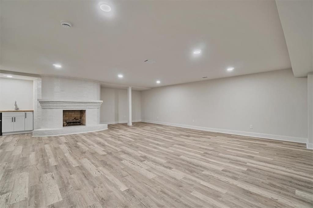 3062 Katherine Valley Road Decatur, GA 30032 - Photo 45 of 61 an empty room with wooden floor and fireplace