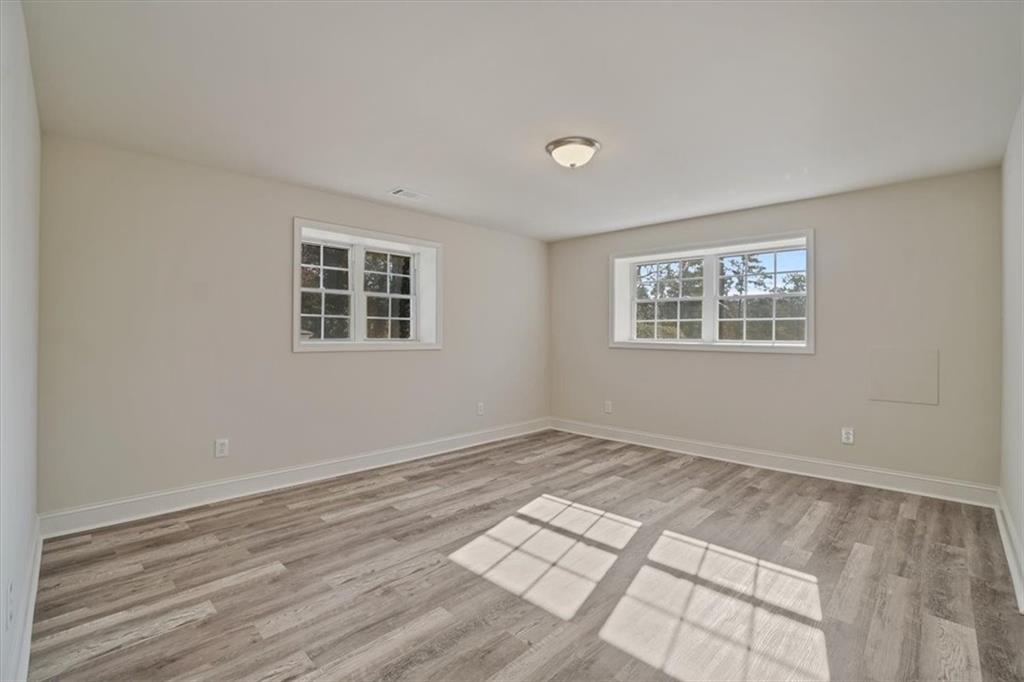 3062 Katherine Valley Road Decatur, GA 30032 - Photo 49 of 61 a view of an empty room with wooden floor and a window