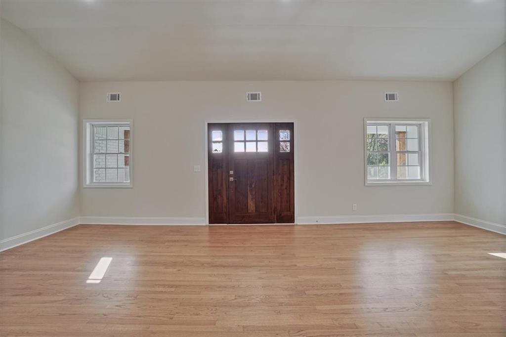 3062 Katherine Valley Road Decatur, GA 30032 - Photo 7 of 61 a view of an empty room with wooden floor and a window