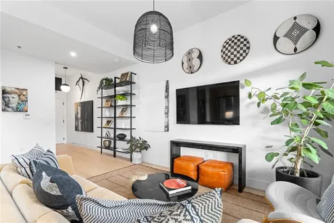 a bedroom with a bed and painting on the wall