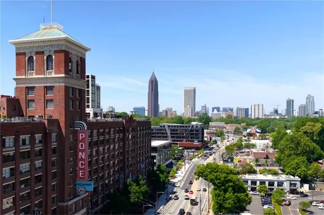 a living room with furniture a chandelier and a large window