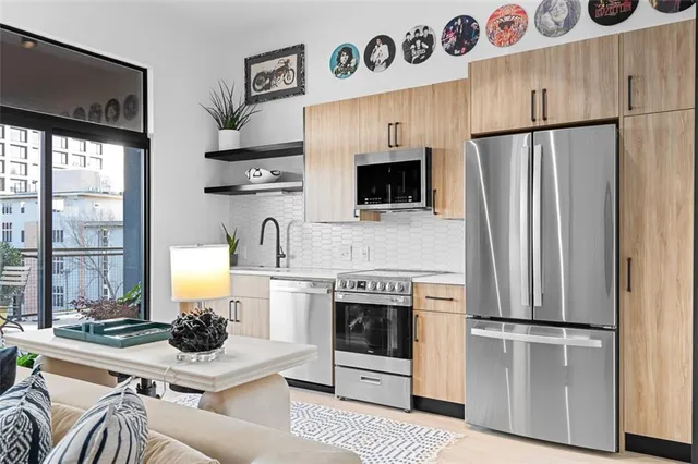 a view of a dining room kitchen with furniture and chandelier