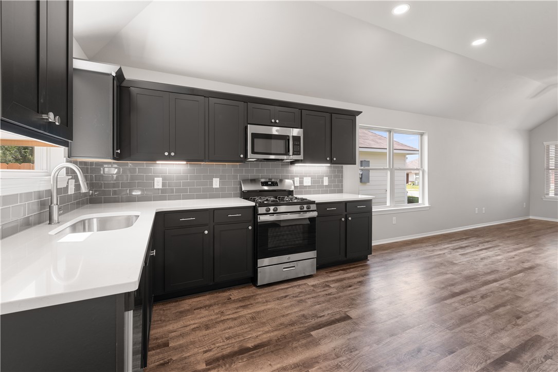 2869 Messenger Way Bryan, TX 77803 - Photo 11 of 23 a kitchen with stainless steel appliances granite countertop a sink stove and cabinets