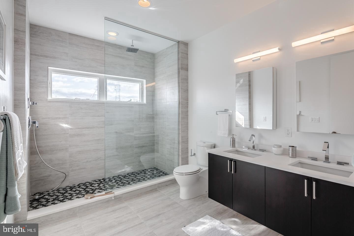 520 Fairmount Avenue Philadelphia, PA 19123 - Photo 11 of 24 a bathroom with a double vanity sink mirror and shower