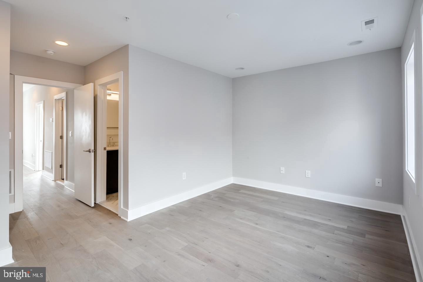 520 Fairmount Avenue Philadelphia, PA 19123 - Photo 16 of 24 a view of an empty room with wooden floor and a window