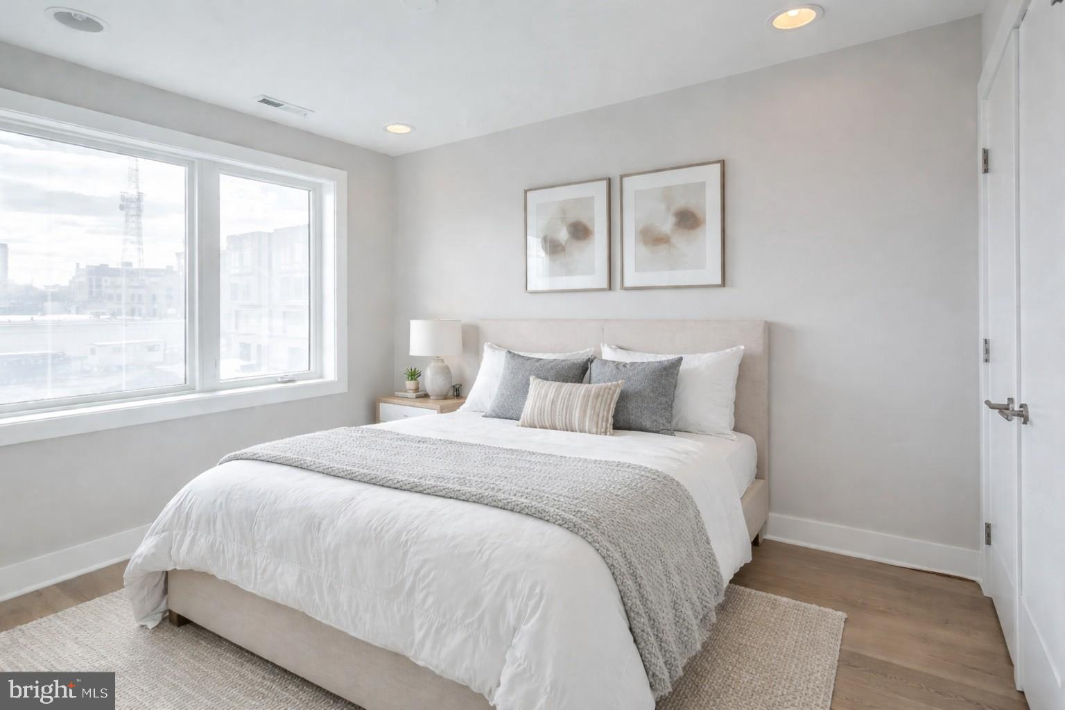 520 Fairmount Avenue Philadelphia, PA 19123 - Photo 17 of 24 a large bed sitting in a bedroom next to a window