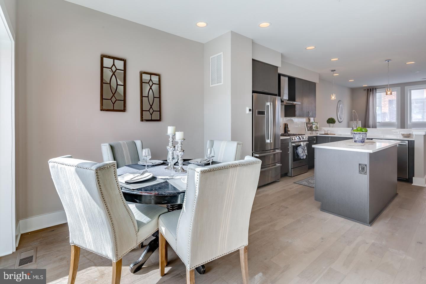 520 Fairmount Avenue Philadelphia, PA 19123 - Photo 4 of 24 a dining room with stainless steel appliances kitchen island granite countertop a dining table chairs and a refrigerator