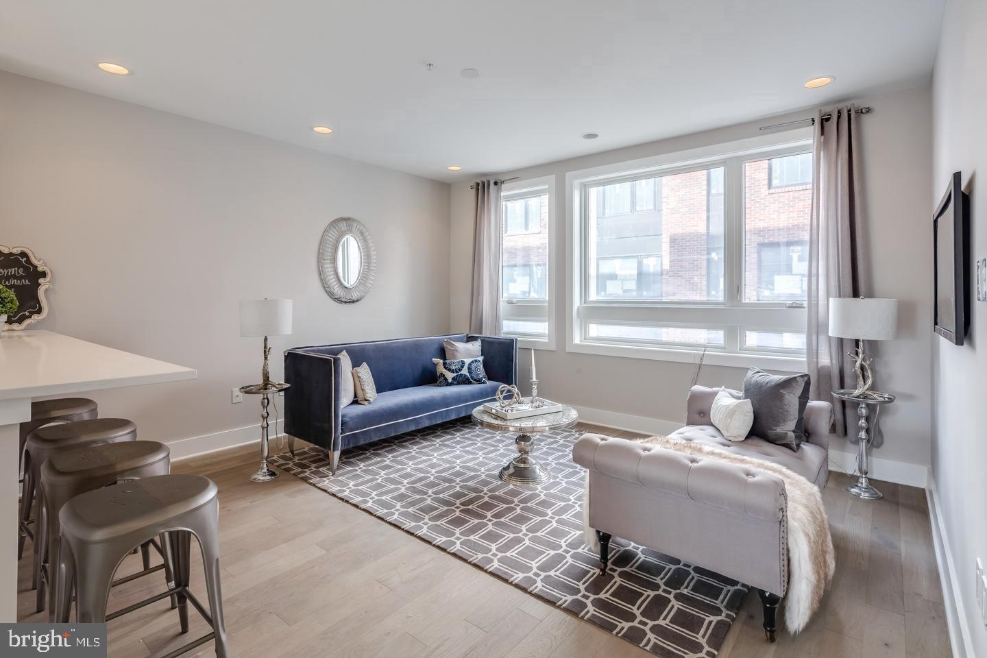 520 Fairmount Avenue Philadelphia, PA 19123 - Photo 7 of 24 a bedroom with a bed a couch and a large window