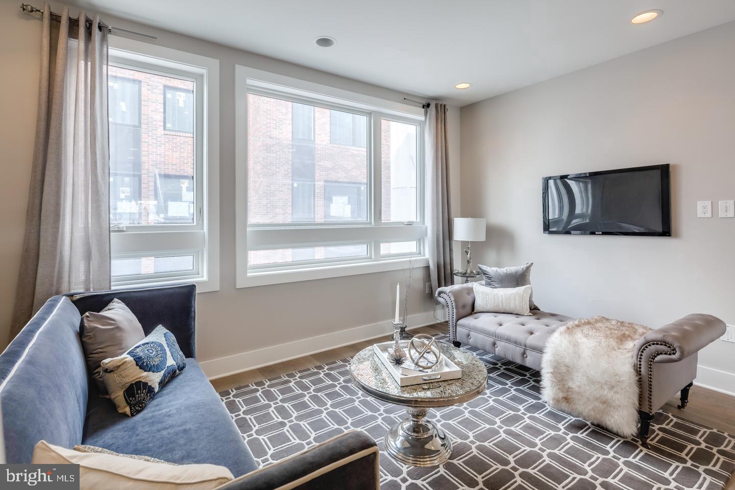 520 Fairmount Avenue Philadelphia, PA 19123 - Photo 8 of 24 a living room with furniture and a flat screen tv