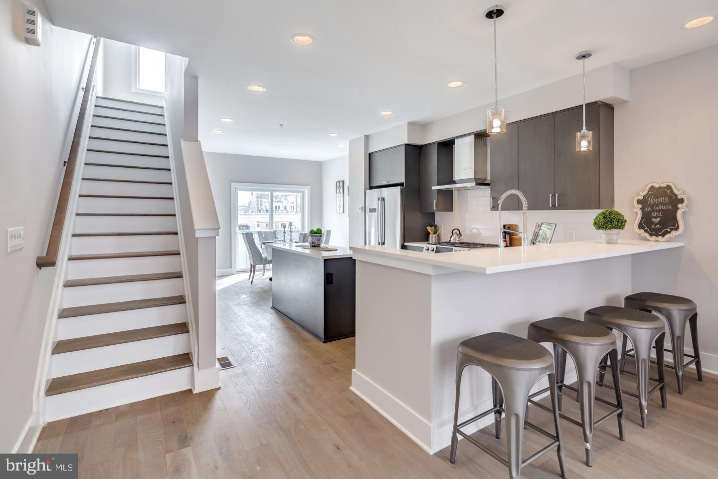 520 Fairmount Avenue Philadelphia, PA 19123 - Photo 9 of 24 a kitchen with kitchen island stainless steel appliances a sink and a refrigerator