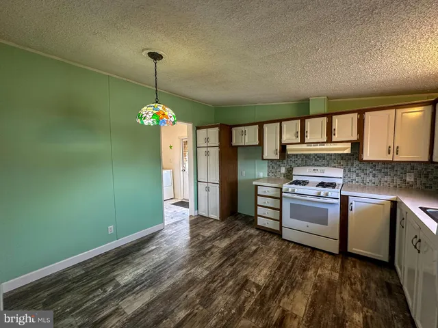 a kitchen with kitchen island a sink stainless steel appliances and cabinets