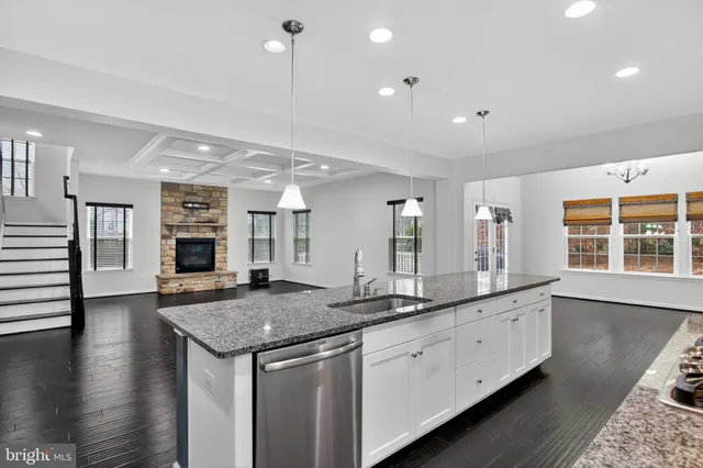 a view of center island wooden floor and windows