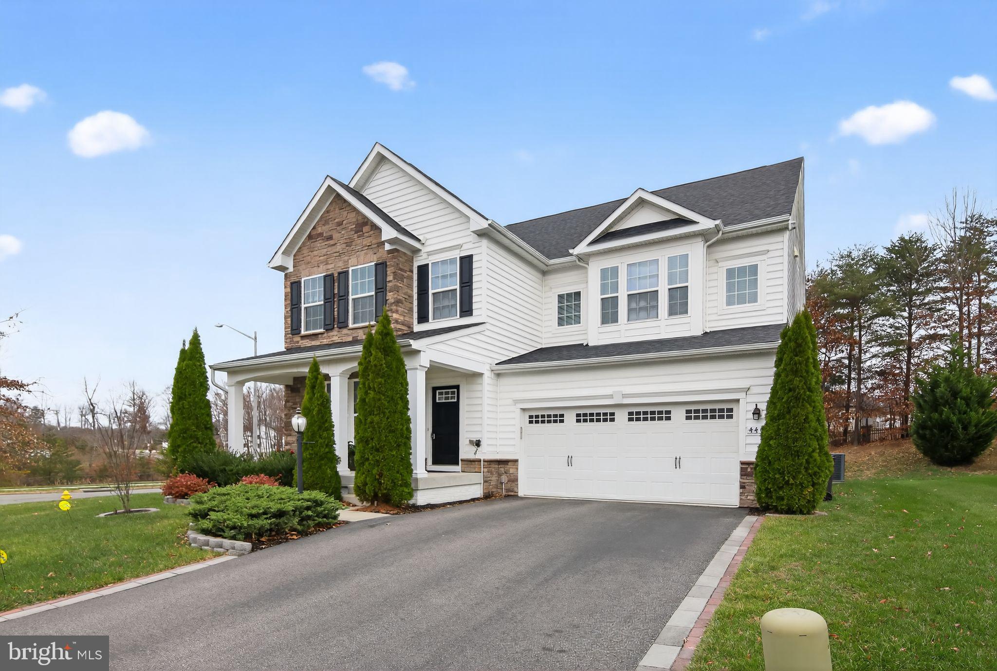 4401 Weejun Loop Woodbridge, VA 22192 - Photo 2 of 35 a front view of a house with a garden and plants