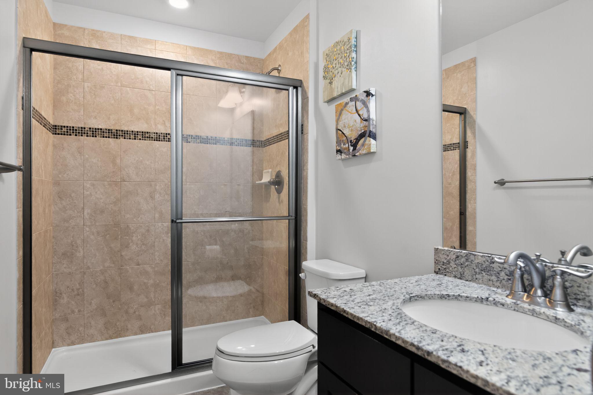 4401 Weejun Loop Woodbridge, VA 22192 - Photo 23 of 35 a bathroom with a granite countertop sink toilet and shower