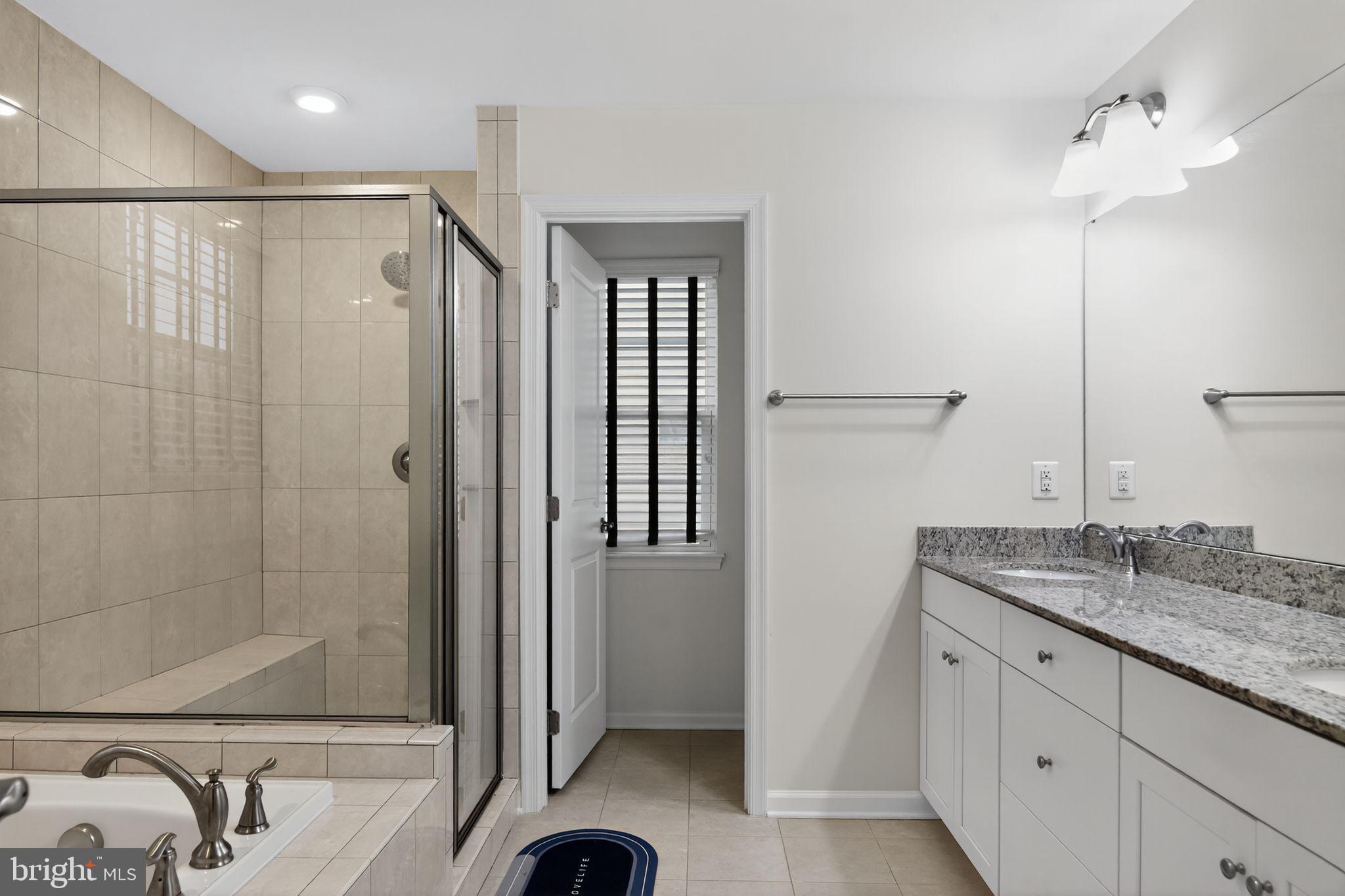 4401 Weejun Loop Woodbridge, VA 22192 - Photo 26 of 35 a bathroom with a granite countertop sink a mirror and shower