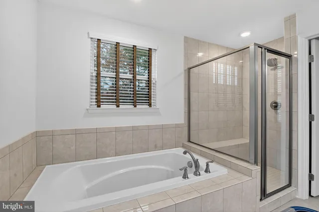 a bathroom with a bathtub and a shower