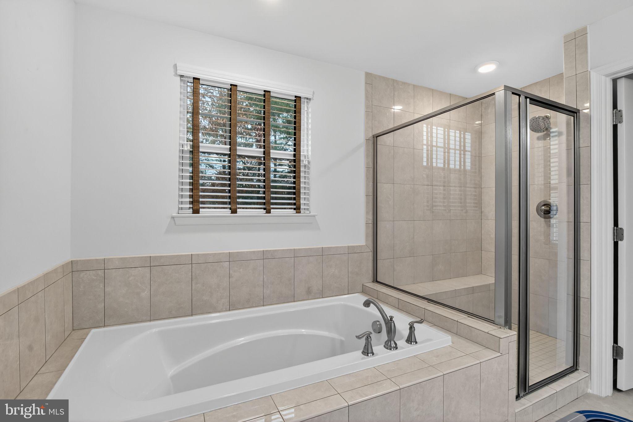 4401 Weejun Loop Woodbridge, VA 22192 - Photo 27 of 35 a bathroom with a bathtub and a shower