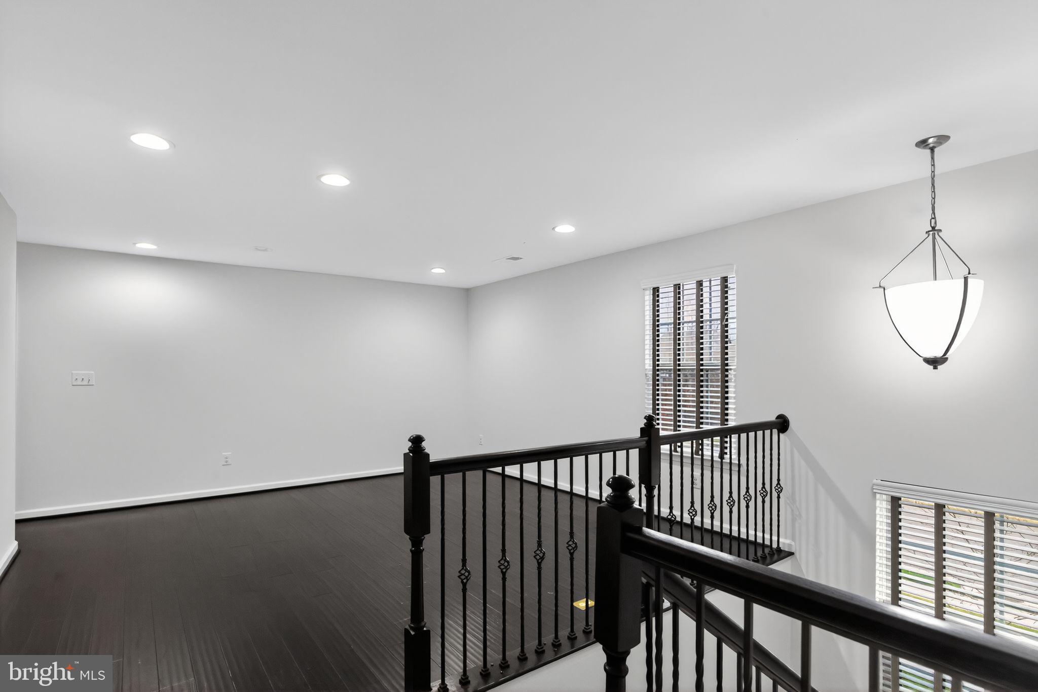 4401 Weejun Loop Woodbridge, VA 22192 - Photo 3 of 35 a view of a hallway with wooden floor and windows