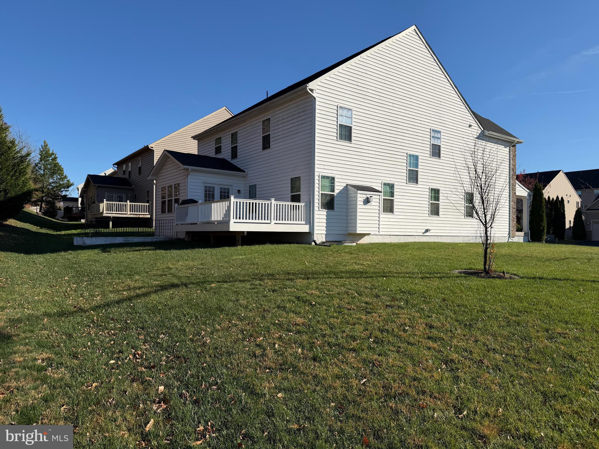 4401 Weejun Loop Woodbridge, VA 22192 - Photo 34 of 35 a view of a white house with a yard