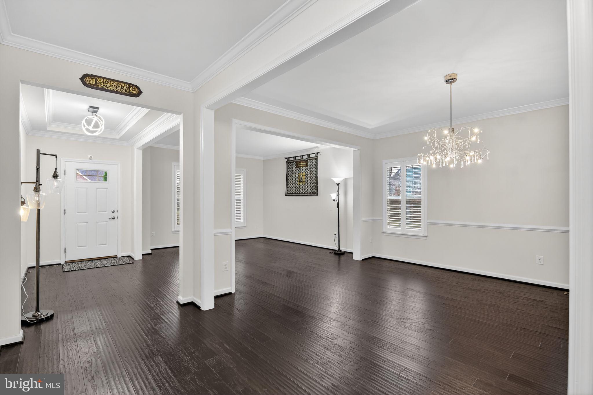 4401 Weejun Loop Woodbridge, VA 22192 - Photo 4 of 35 a view of a room with wooden floor chandelier and windows