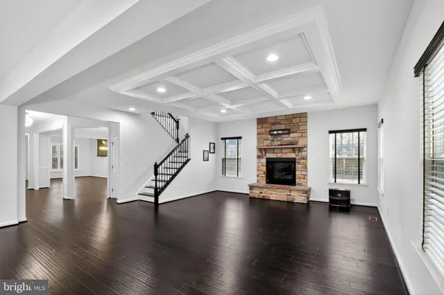 a view of an entryway with wooden floor staircase and windows