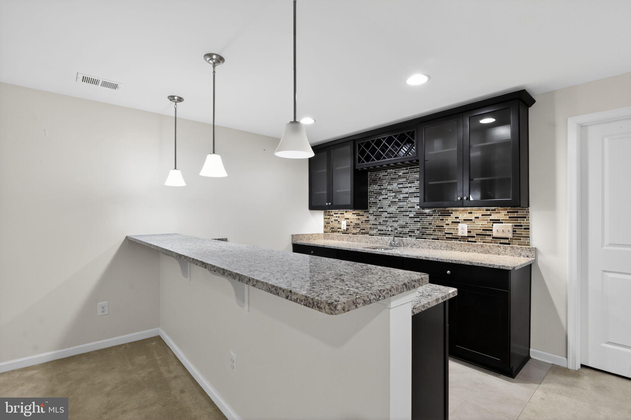 4401 Weejun Loop Woodbridge, VA 22192 - Photo 9 of 35 a kitchen with stainless steel appliances granite countertop a sink and a refrigerator