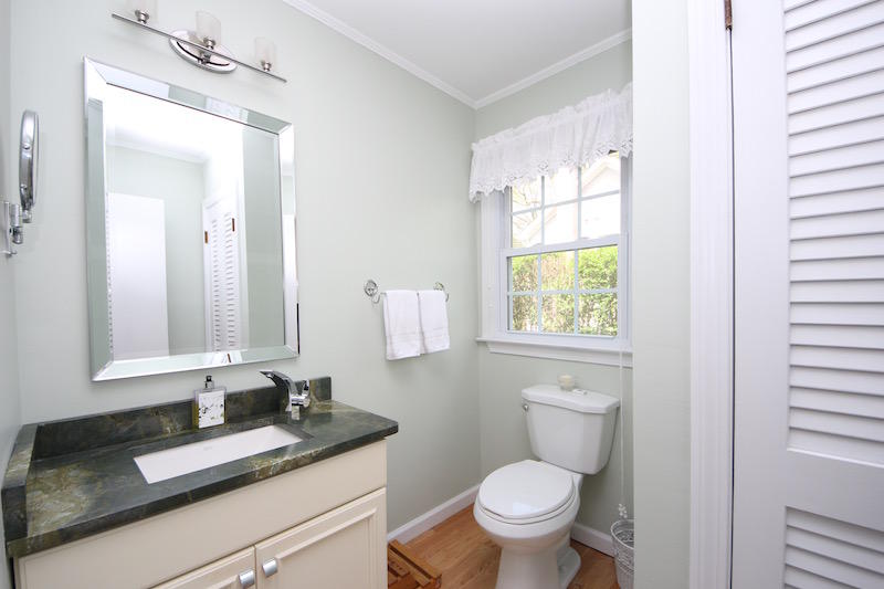 3 Miles Road Darien, CT 06820 - Photo 11 of 32 a bathroom with a granite countertop toilet a sink and a mirror
