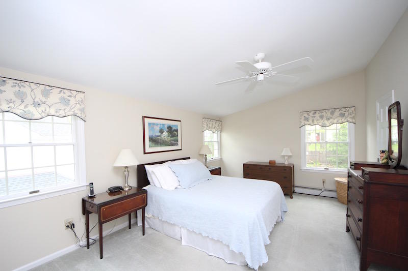 3 Miles Road Darien, CT 06820 - Photo 12 of 32 a bedroom with a bed and a chandelier