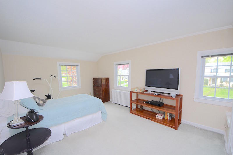 3 Miles Road Darien, CT 06820 - Photo 18 of 32 a bedroom with furniture and a flat screen tv