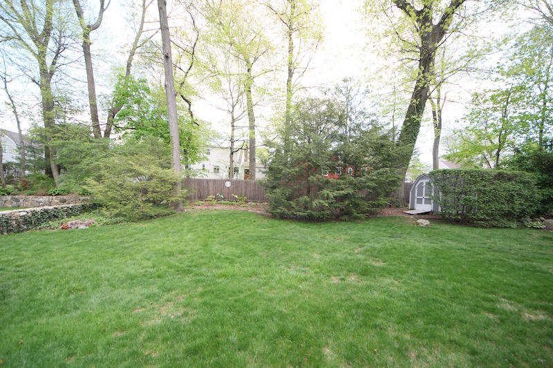 3 Miles Road Darien, CT 06820 - Photo 25 of 32 a backyard of a house with lots of green space and garden